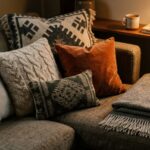 Neutral sofa styled with colorful throw pillows and cozy knit blankets.
